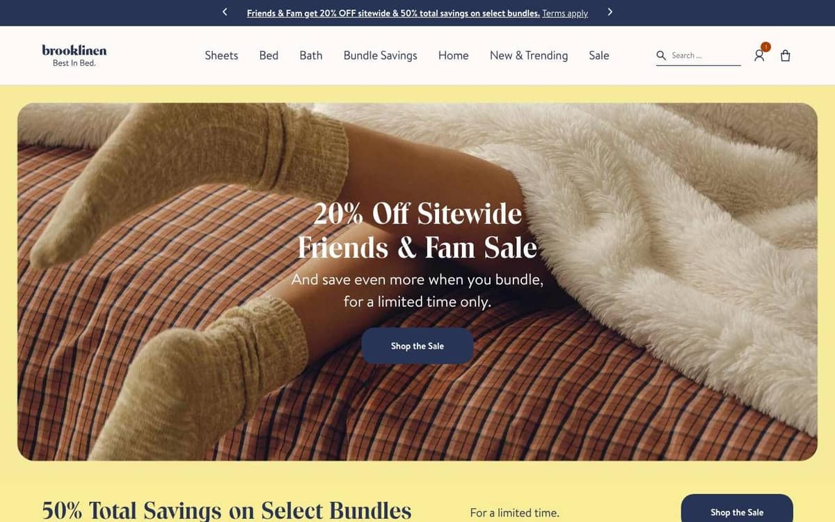 Brooklinen homepage on a desktop screen: a sale headline and one Shop the Sale button over a photo of socks on a bed
